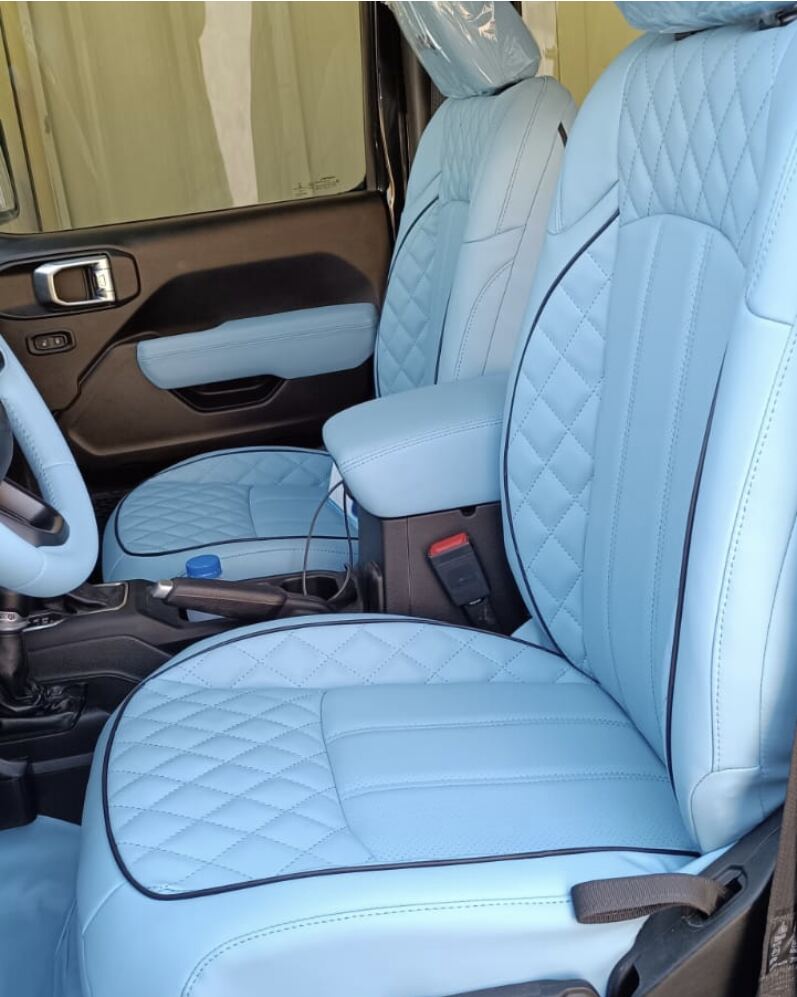 Jeep Wrangler interior in pale blue leather with diamond stitching, navy piping, matching armrest and steering wheel